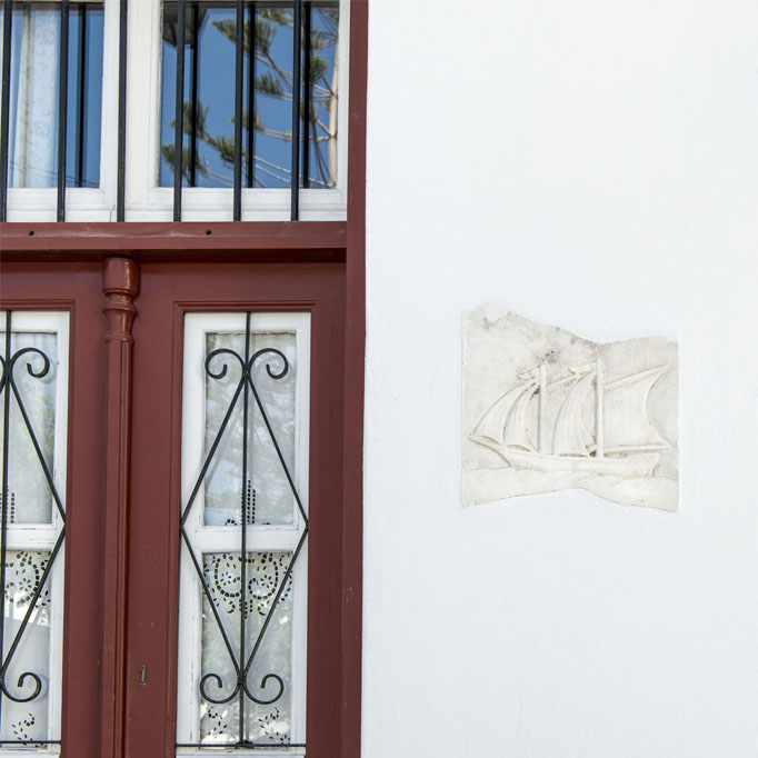 The white-washed walls form playful niches, emblazoned with plaster relief artwork details