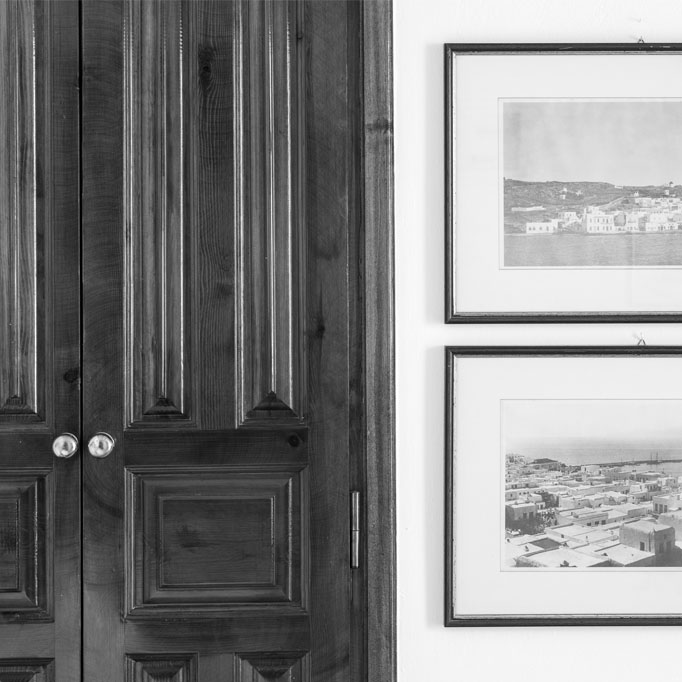 History revisited, with old framed photographs of Mykonos, and clean-cut neoclassical style doors